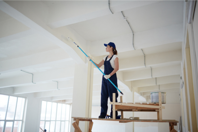 Commercial Painter on a scaffold inside property painting